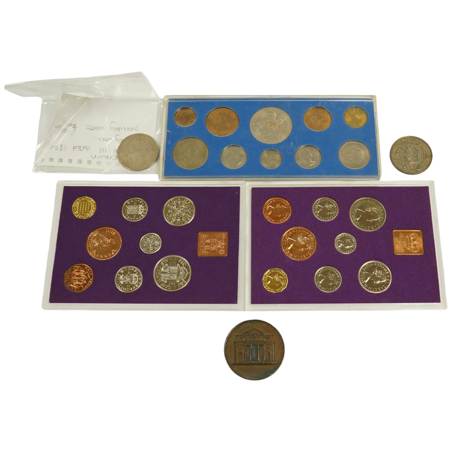 A small collection of coins including two 1970 proof sets, a 1953 set, a George III crown, a 1933 George V crown and a medallion for the Argyle Chapel, Bath. Condition - fair